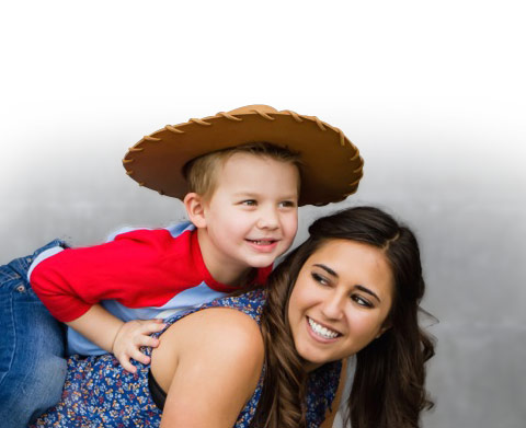 Boy in cowboy hat playing